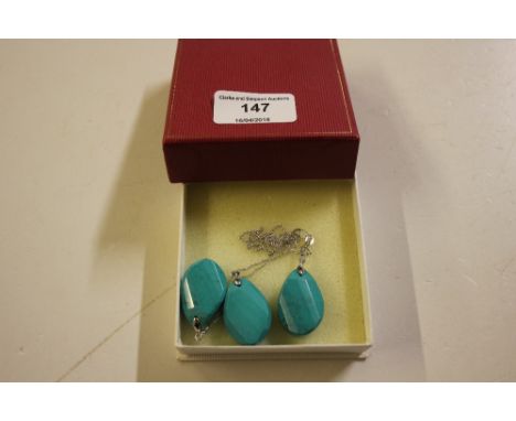 A silver chain hung with a turquoise pendant; and a pair of matching ear-rings 