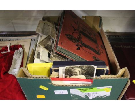 A box containing post-card albums, photo albums, and loose post-cards and photos