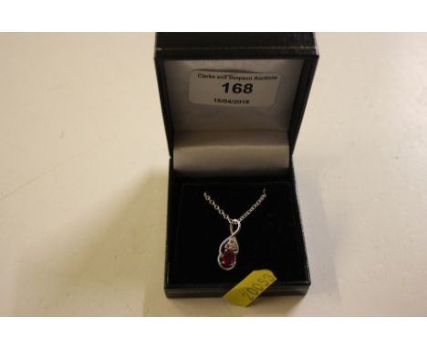 A ruby set and silver pendant hung to a fine link chain 