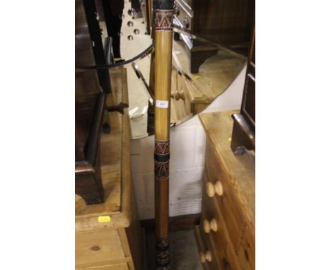 A wrought iron CD rack in the form of a dog; and a didgeridoo 