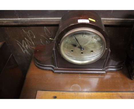 A mahogany three hole mantel clock
