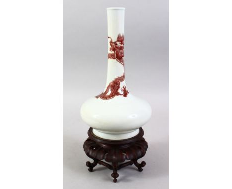 A GOOD CHINESE IRON RED PORCELAIN DRAGON BOTTLE VASE, the body of the vase with an intertwined five claw dragon, the base bea