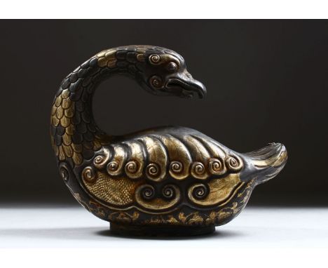 A GOOD EARLY POSSIBLY TANG PERIOD CHINESE SILVER AND GILT MODEL OF A DUCK, in a seated position with its head looking back, w
