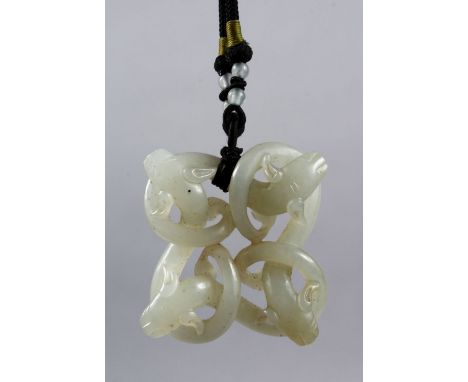 A GOOD 18TH / 19TH CENTURY CHINESE CARVED CELADON JADE PENDANT OF CHILONG, carved to depict four intertwined chilong / beasts