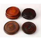 FOUR CHINESE 19TH CENTURY HARDWOOD STANDS, carved and pierced, housing vases from 11.5cm down to 9.