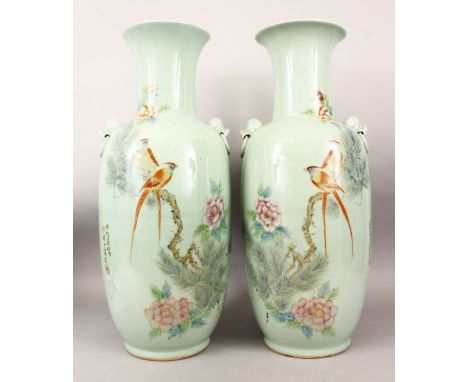 A LARGE PAIR OF CHINESE 20TH CENTURY CELADON FAMILLE ROSE PORCELAIN VASES, both vases with twin moulded lion dog head mask ha