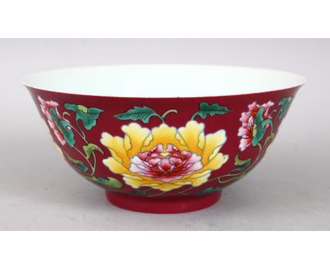 A GOOD CHINESE CORAL GROUND FAMILLE ROSE PORCELAIN BOWL, the body of the bowl with formal scrolling flora, the base with a fo