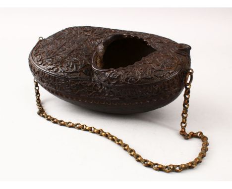 A GOOD ISLAMIC CARVED COCO DE MER KASHKOOL, decorated with carved calligraphy, with a chain link handle, 26cm wide x 14cm wid