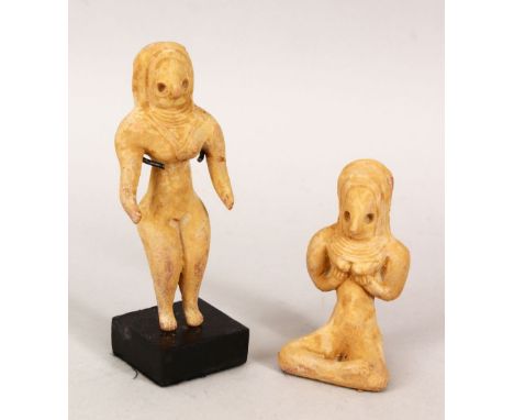 TWO ISLAMIC TERRACOTTA AFGHANISTAN CERAMIC FIGURES, one with stand, one 13.5cm high, the other 9cm high.