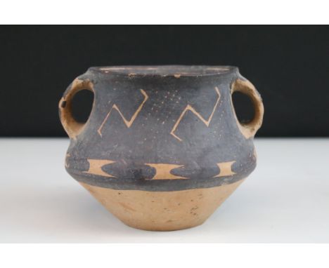 An Ancient Chinese neolithic pottery twin handled jar.