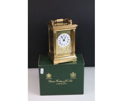 A brass repeating carriage clock, by Charles Frodsham, 20th century, the case with swing handle above moulded cornice with fl