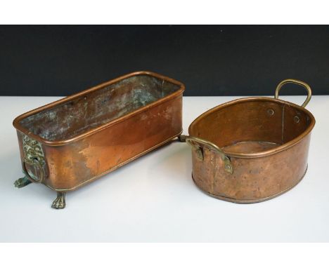 Copper rectangular planter with rolled rim, brass lion mask drop ring handles and four brass lion paw feet H 11cm, W 29cm, D 