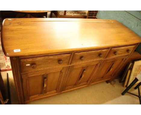 Ercol elm sideboard / dresser base with three panelled cupboard doors and three drawers to frieze with turned knob handles. M