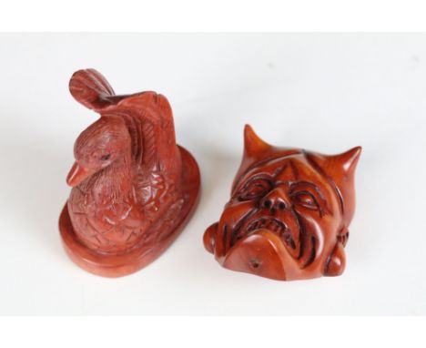 Two signed carved wooden netsuke figures to include Devils Head and Swan
