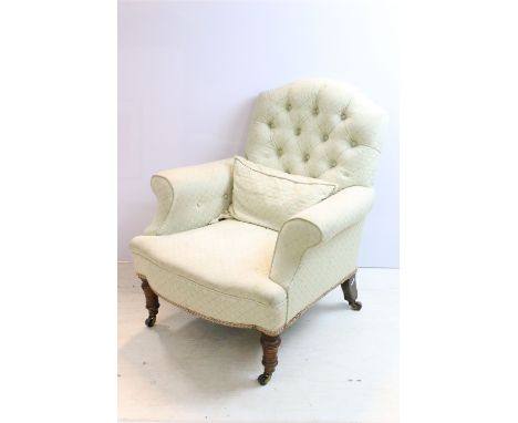 19th Century Victorian arm chair having button back upholstery, raised om turned legs with ceramic castors. Measures approx 7