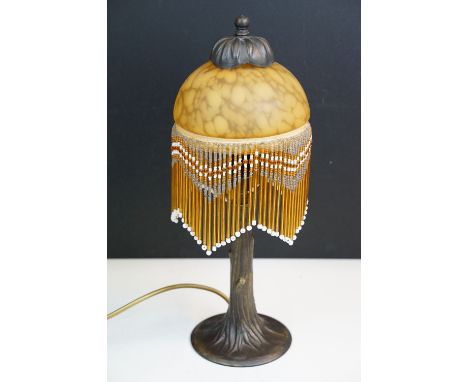 Art Nouveau style table lamp with delicate tree trunk design base and a glass shade with beaded fringing, H 39cm