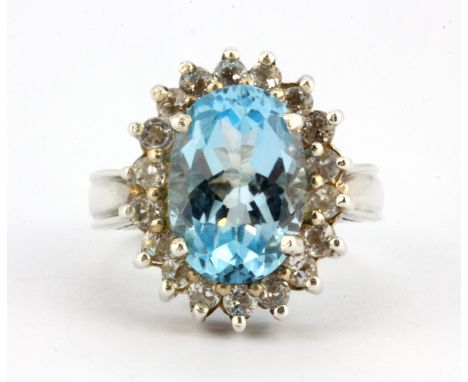 A 925 silver ring set with a large oval cut blue topaz and white stones, (M).