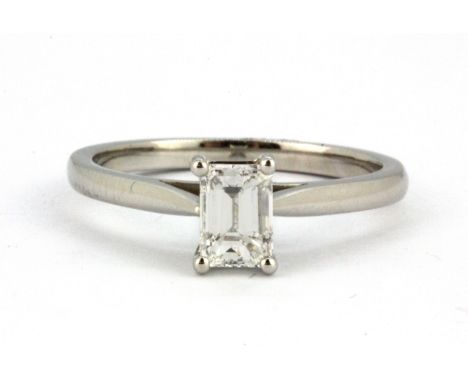 A 950 platinum solitaire ring set with an 0.72ct emerald cut diamond, with certificate, clarity VVS1, colour E, (N.5).