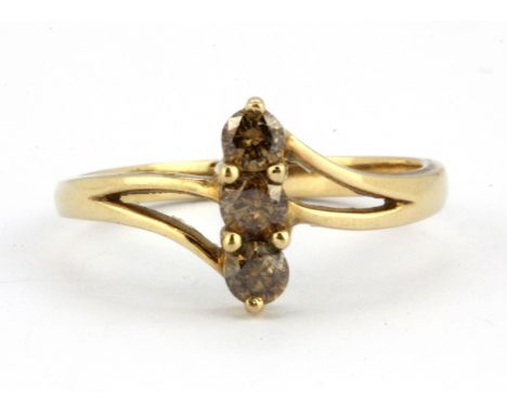 A 9ct yellow gold ring set with three brilliant cut fancy brown diamonds, (U).
