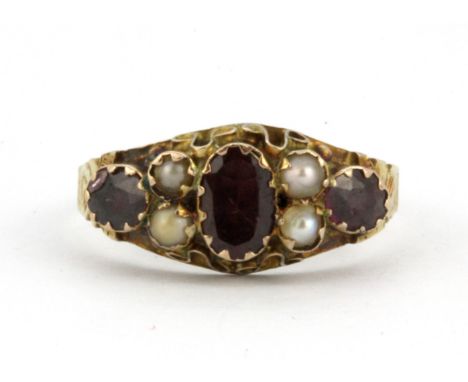 An antique 9ct yellow gold (stamped 9ct) ring set with almandine garnets and seed pearls, (M.5).
