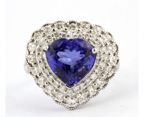 An 18ct white gold (stamped 750) ring set with a heart cut tanzanite surrounded by brilliant cut diamonds, tanzanite approx. 