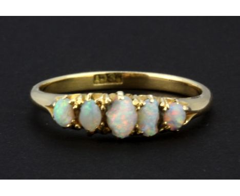 An 18ct yellow gold ring set with five cabochon cut graduated opals, (one opal a/f), (P).