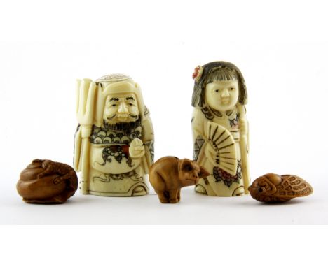 Two carved bone figural netsuke and three fruitwood ojime, netsuke H. 5cm.