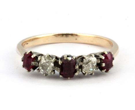 A yellow metal (tested high carat gold) ring set with old cut diamonds and rubies, (wear to rubies), (R).