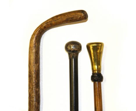 A hallmarked silver topped walking cane, a weighted club top walking cane and walking stick.