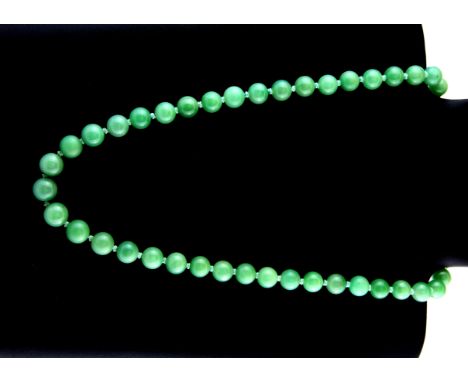 An old Chinese necklace of jade beads on a silver gilt clasp.