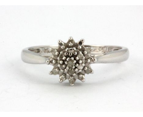 A 9ct white gold diamond set cluster ring, (L.5).