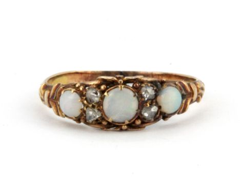 A yellow metal (tested 9ct gold) opal and diamond set ring, (O).