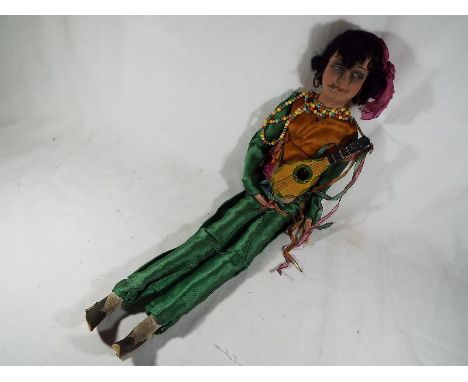 A vintage wind-up musical dressed doll by Ebaso with ceramic hands and face, 60 cm (high)
