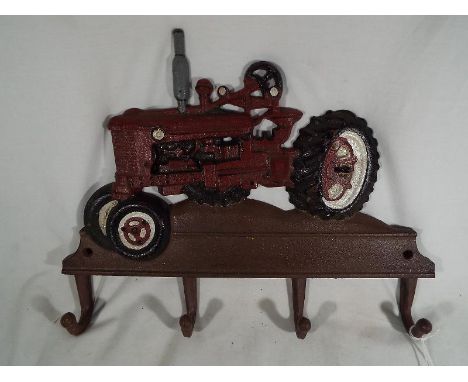 A cast iron wall mounted novelty coat hangar with tractor decoration - Est £20 - £30