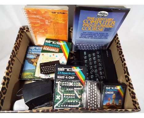 A Sinclair ZX Spectrum gaming console with power cables and accessories to include a small quantity of games