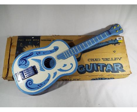 A Chad Valley guitar with nylon strings, boxed in good condition