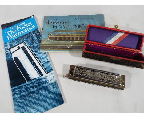 The Super Chromonica chromatic harmonica by Hohner in original case with accompanying manual