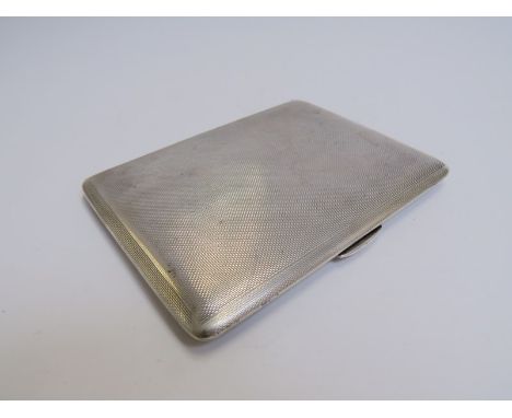 A W H Manton Ltd silver engine turned cigarette case with presentation inscription to the interior, Birmingham 1945, some vis