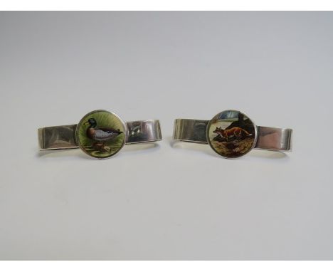 Two R.H. Halford &amp; Sons silver napkin rings with central painted enamel cartouche, 71g 