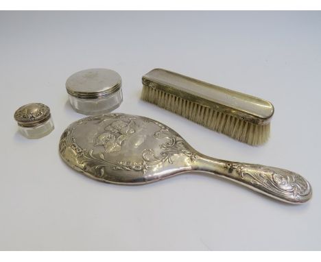 Silver backed and topped dressing table items, mirror, brush and two pots, various makers and dates 