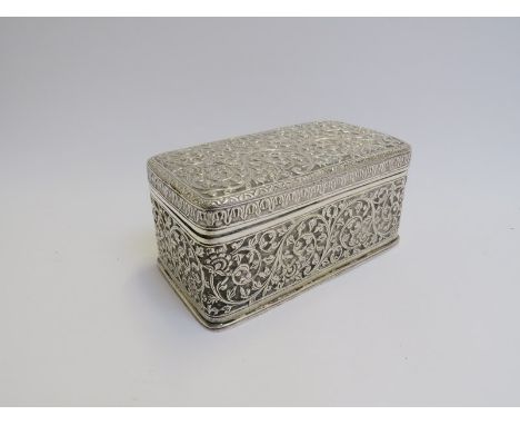An Indian white metal trinket box with all over foliate scrolled design, 7.5cm x 15cm x 8.5cm, 433g 