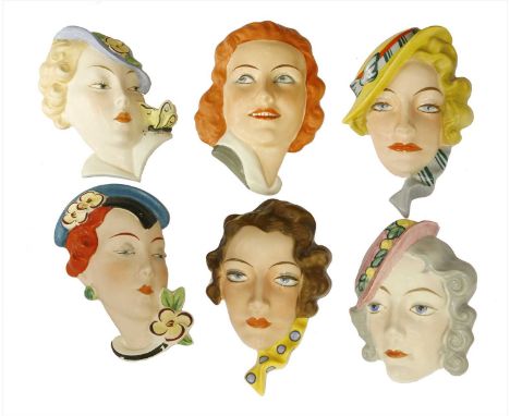 Five Art Deco Czechoslovakian pottery wall masks,two printed 'Royal Dux', most inscribed with five digit numbers,largest 21.5