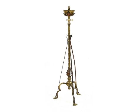 An Arts and Crafts brass and copper-mounted standard lamp,in the style of W A S Benson, mounted with copper-embossed acanthus