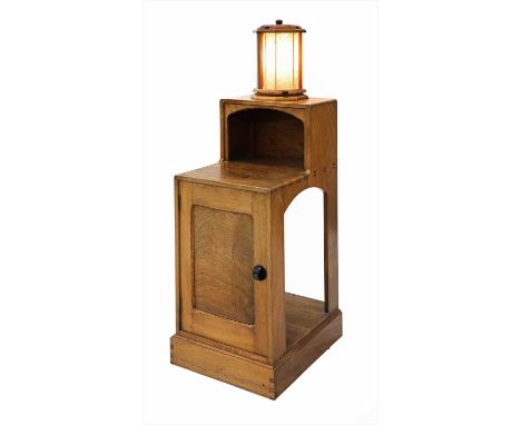 A walnut bedside cabinet,dated 1935, designed by Stanley Webb Davies, craftsman Bob Willett, with an integral revolving lamp,