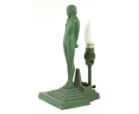 An Art Deco lamp, green patinated cast base metal, depicting a nude female atop a stepped base,26.5cm highCondition report: G