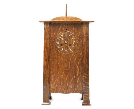 A rare Arts and Crafts oak architectural clock,  designed by C F A Voysey (1857-1941), c.1902, with a domed top with a wood p