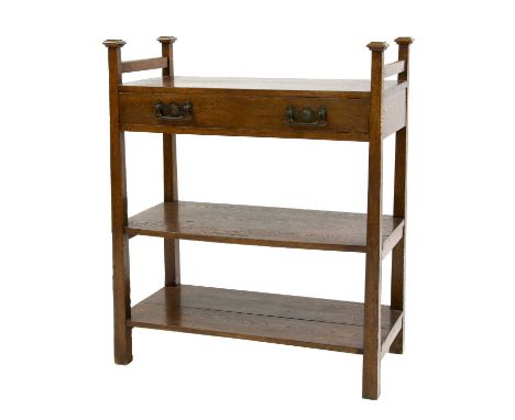 An Arts and Crafts oak breakfast buffet,in the style of Liberty & Co., with a single cutlery drawer over two shelves,90cm wid