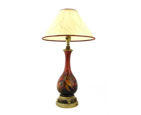 A Moorcroft flambé 'Orchid' table lamp,with gilt mounts,31cm high with conical shade, 41cm overall