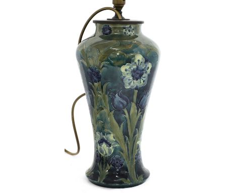 A Moorcroft Florian baluster table lamp,early 20th century, by William Moorcroft for Liberty, decorated with flowers on a blu