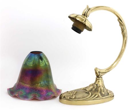 An Art Nouveau-style gilt metal lamp, with foliate base and scrolled arm, the iridescent shank with pulled loop decoration, i